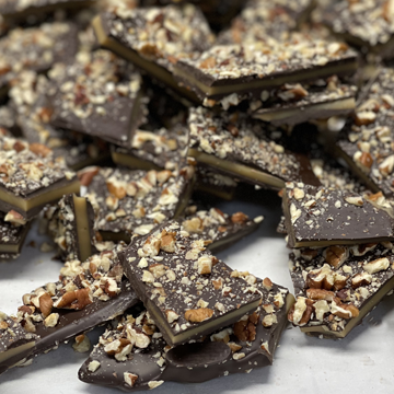 viktoria richards dark chocolates pecan toffee stacked randomly on a table